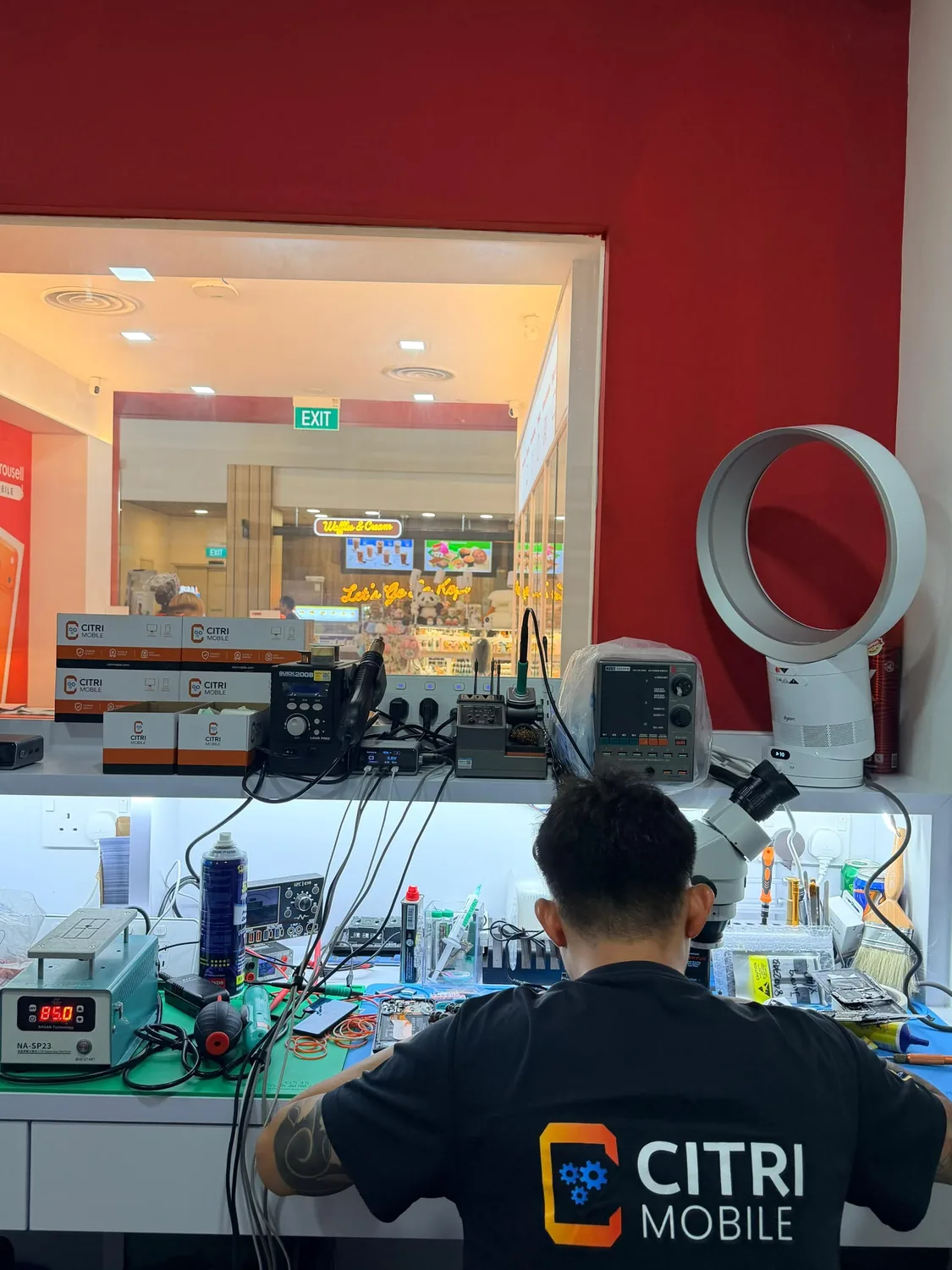 Citri Mobile technician doing board-level work under a microscope